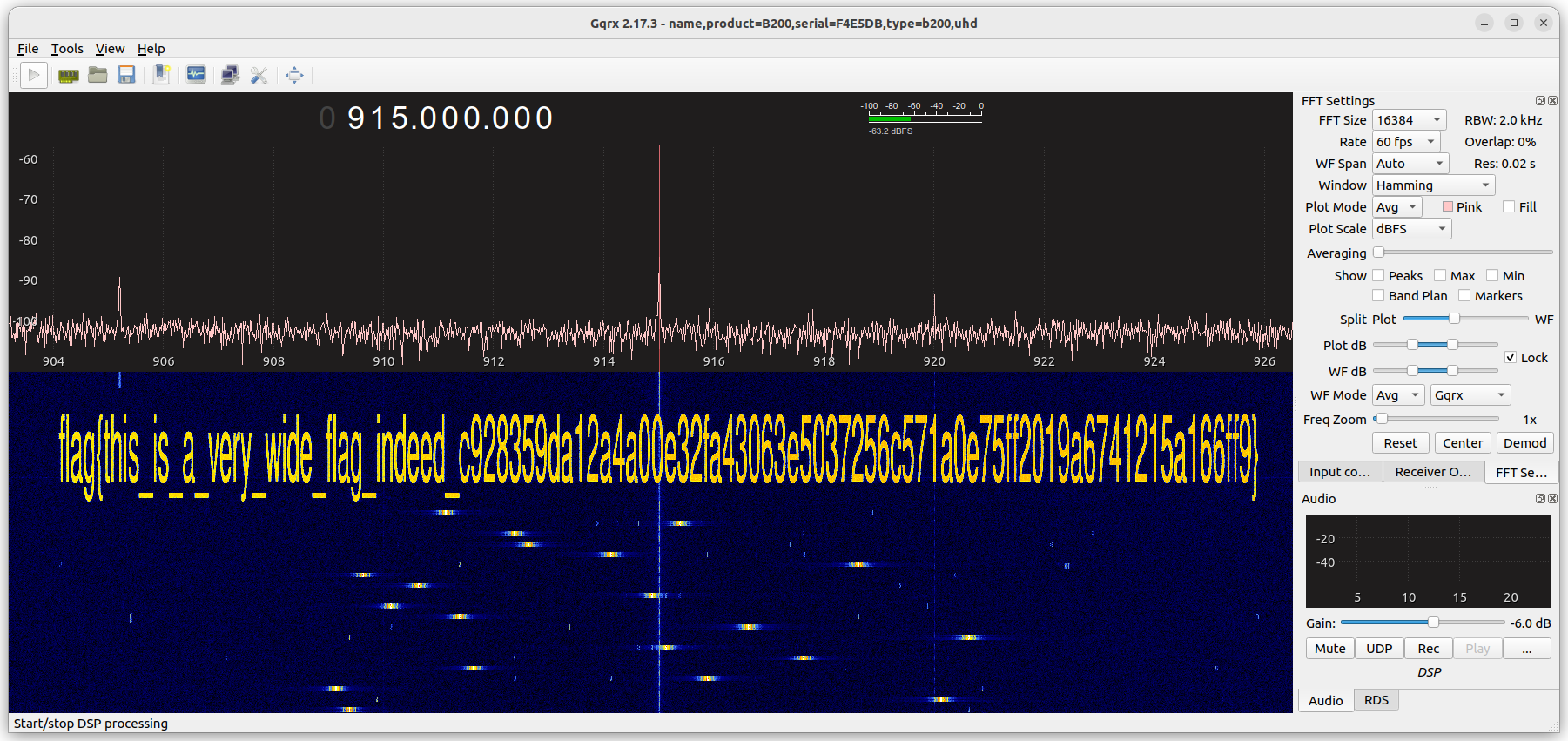 Screenshot of Gqrx, showing "flag{this_is_a_very_wide_flag_indeed_c928359da12a4a00e32fa43063e5037256c571a0e75ff2019a6741215a166ff9}" in the waterfall